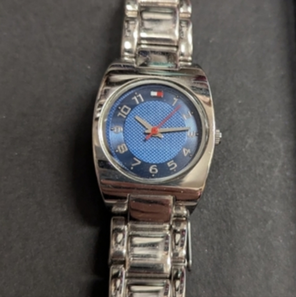 Tommy Hilfiger watch. Blue face with red and while accents. Silver tone